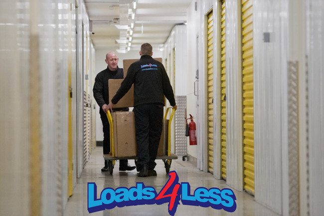 Image of Loads4Less staff rolling items down a hallway using trolley. This being Big Yellow self storage Norwich.